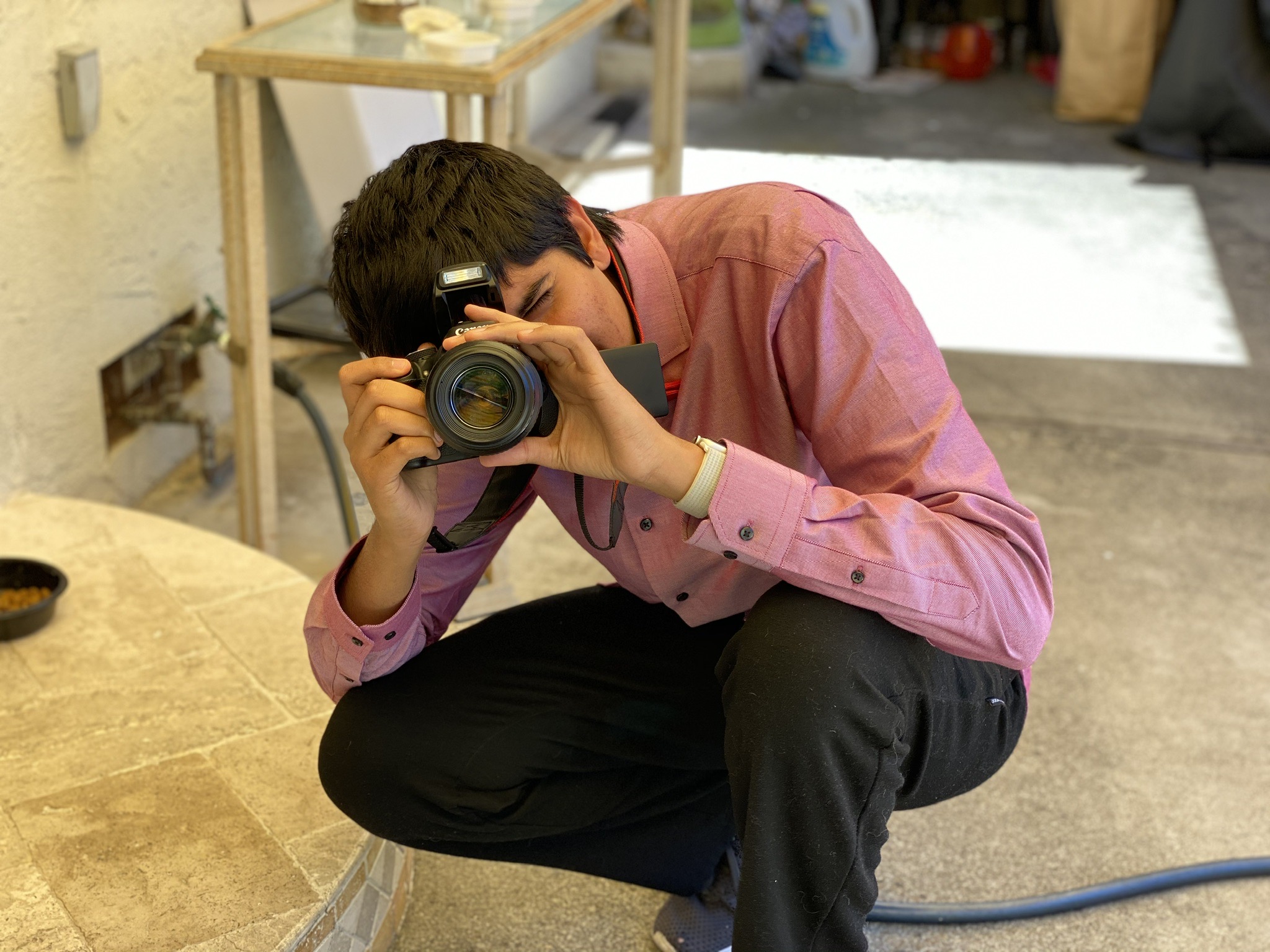 Vardhan Agrawal taking a photo using a DSLR camera